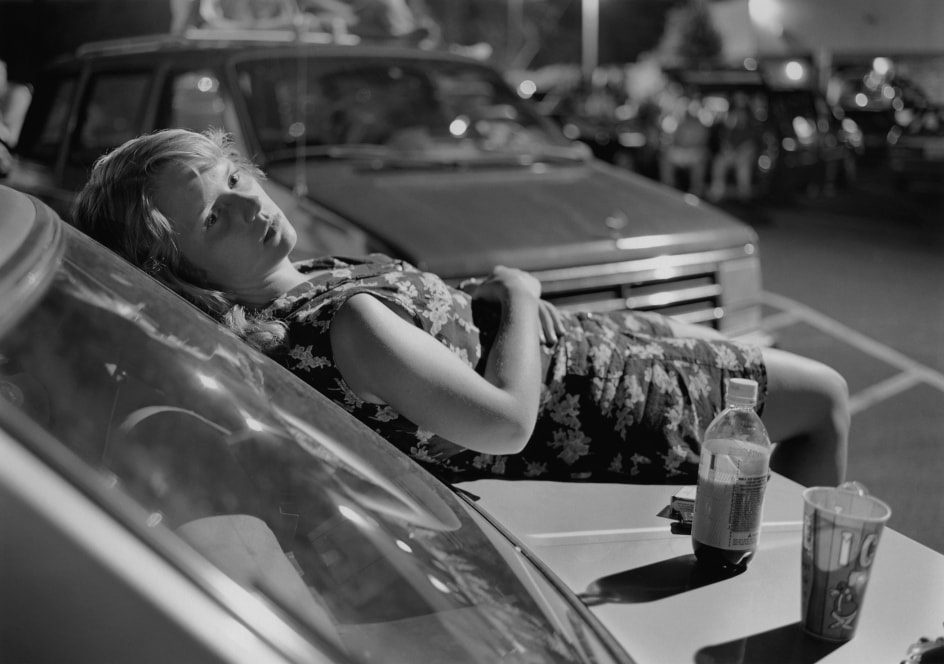 Mark Steinmetz, Athens, GA (Girl on Hood of Car), 1996.&nbsp;Gelatin silver print, 20 x 24 inches.