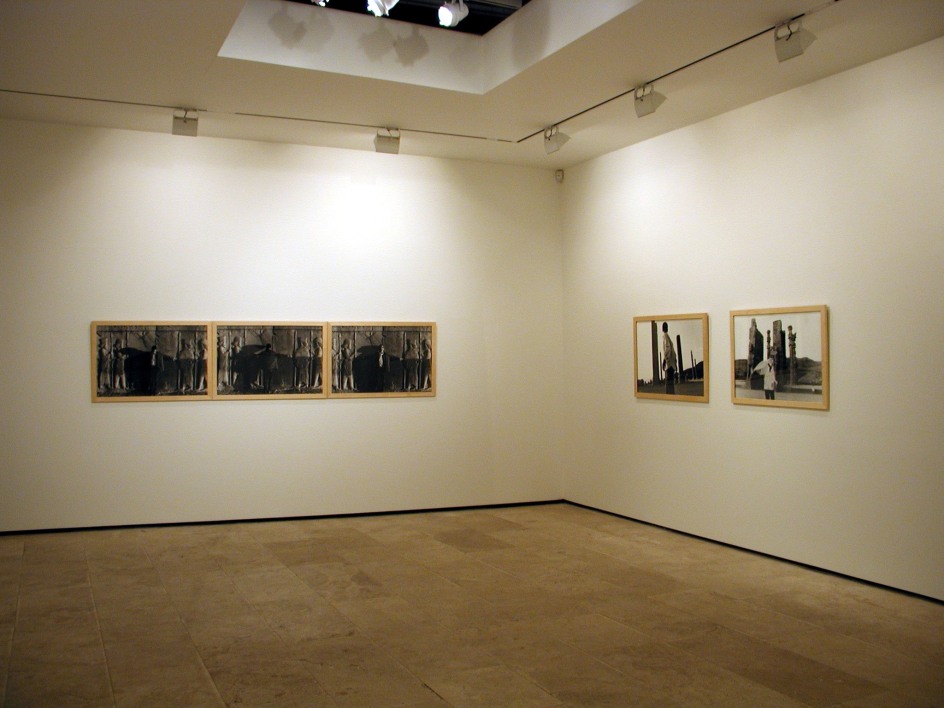 Two groupings of photographs on opposite walls in the exhibition Sadegh Tirafkan at Lehmann Maupin in New York in 2004