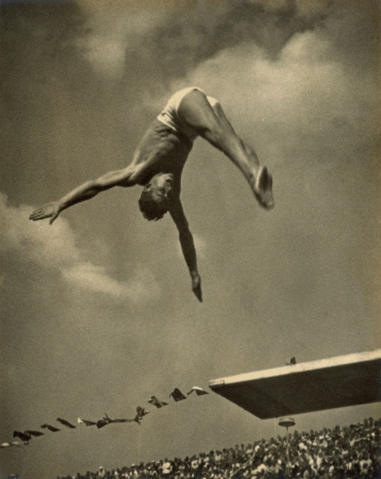 22. Leni Riefenstahl (German, 1902-2003), 21 - [Marshall] Wayne (One and a half somersaults with running take-off), 1936, Vintage Gelatin Silver Print, 9&rdquo; x 11&rdquo;
