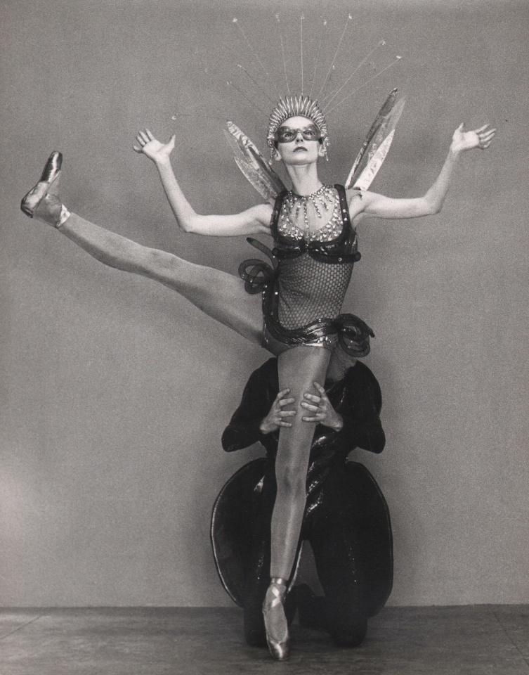 George Platt Lynes, Tanaquil LeClercq &amp; Todd Bolender, Metamorphoses, ​1952. Female dancer poses with one leg and both arms lifted, while male dancer kneels supporting her grounded leg from behind.