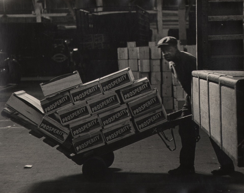 29. Simpson Kalisher, Untitled, ​1949. A worker pushes a card loaded with boxes that read &quot;Prosperity&quot;