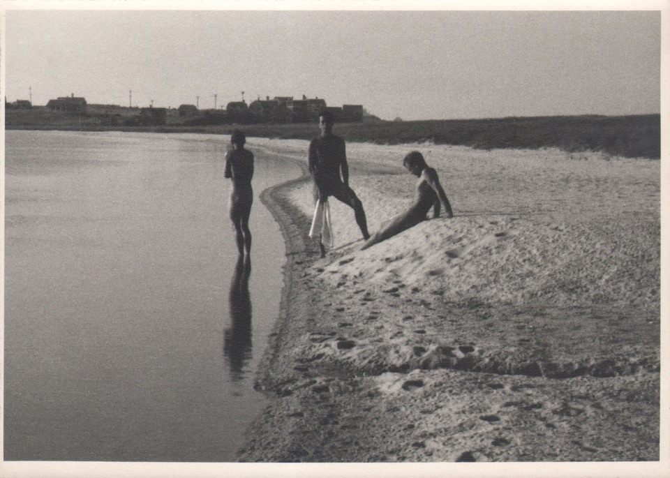 PaJaMa (Margaret French), George Tooker, Paul Cadmus, Jared French, Wauwinet, ​c. 1948. Three men on the beach; two are standing, one is seated. Frame is divided vertically by the sand (right) meeting the sea (left).