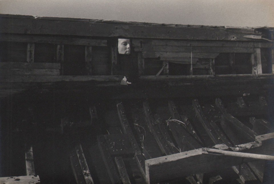 PaJaMa, Untitled, ​c. 1945. A face can be seen in a small square opening in a wooden structure.