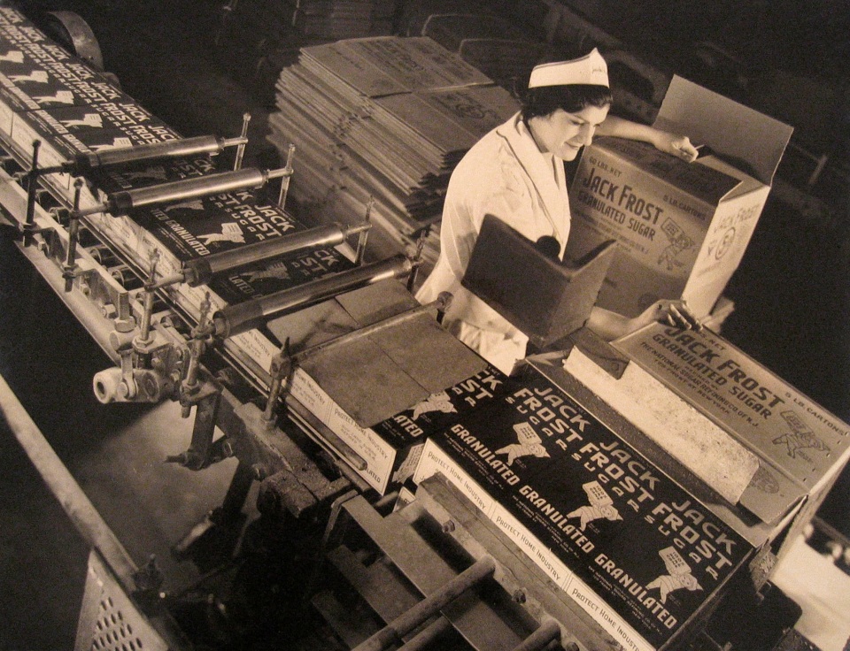 Harold Haliday Costain, Long Island City Plant, ​1935. A woman in white packs boxes with Jack Frost Sugar.