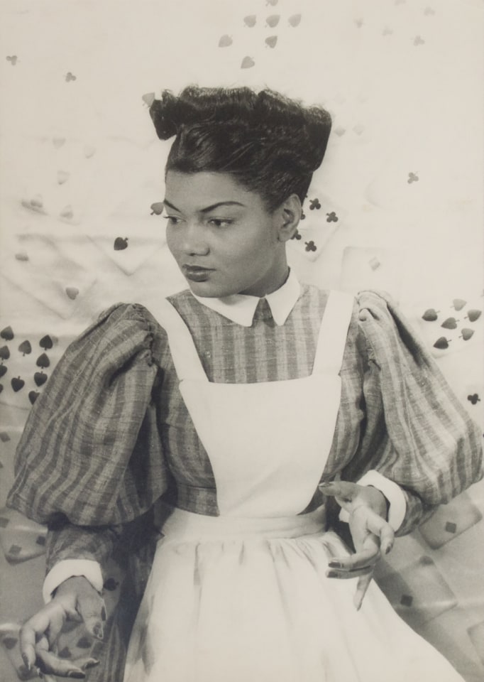 40. Carl Van Vechten, Pearl Bailey in St. Louis Woman, 1946. Seated portrait with subject in a striped dress and apron looking to the lower left of the frame, hands gesturing in front of her.