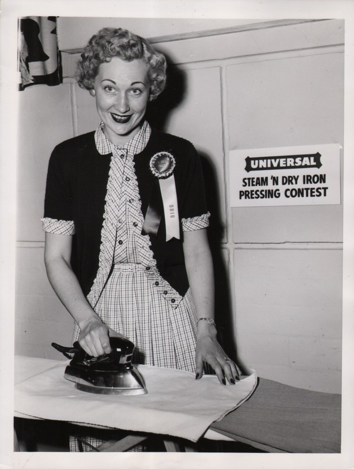 51. Cleveland Press, A Pressing Assignment...is undertaken by Mrs. Ohio, April 26, 1954. A woman stands ironing in front of a sign that reads &quot;Universal steam n' dry iron pressing contest&quot;