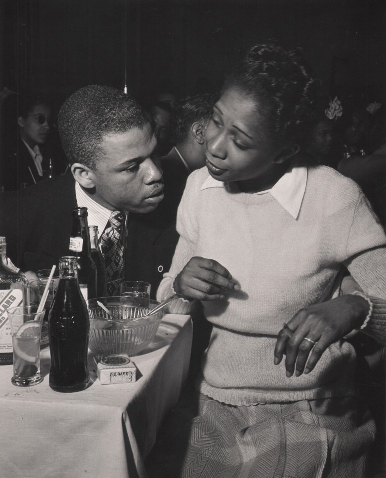 Wayne Miller, Moving to Music, Chicago, ​1946&ndash;1947. A man and woman lean on a table with food, drink, and cigarettes.