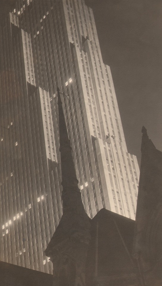 Paul J. Woolf, RCA Building, New York City, c. 1936. RCA building towers beyond the top of the frame with cathedral spires silhouetted in the foreground.