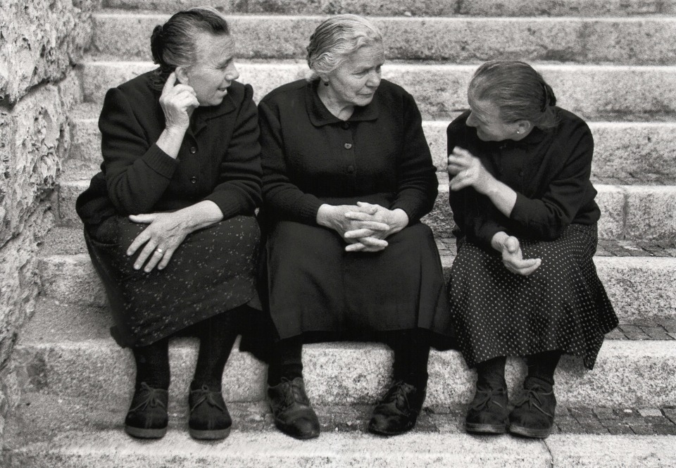 Nino Migliori, The Hands Speak, 1956. Three women sitting on stairs chatting.