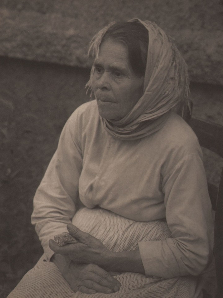 Doris Ulmann, Untitled (Woman in kerchief), ​1928&ndash;1934. Seated woman in a headscarf with arms in lap looking to the left of the frame.