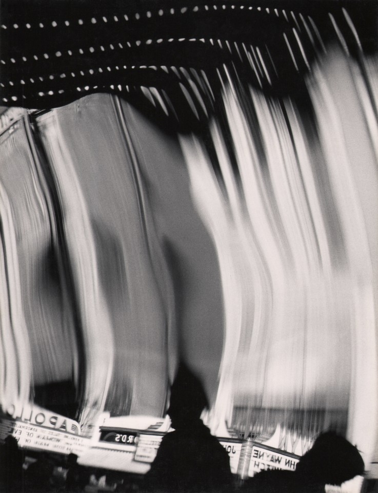 38. Benn Mitchell, Mirrors of Life, 42nd Street, ​1949. Man's silhouette in the lower center of the frame with distorted, elongated lights behind him.