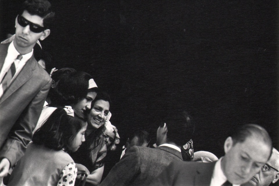 28. Donald Blumberg, In Front of St. Patrick's Cathedral, ​1965. A crowd occupies the lower left diagonal third of the otherwise black frame.