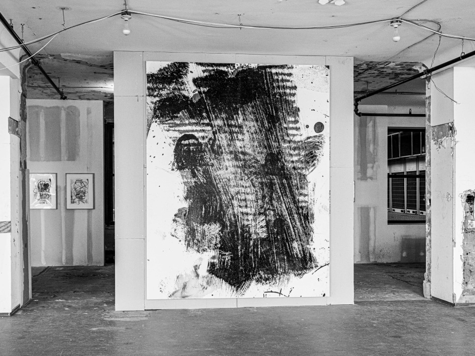 Black and white photo of an abstract painting exhibition in an empty office building