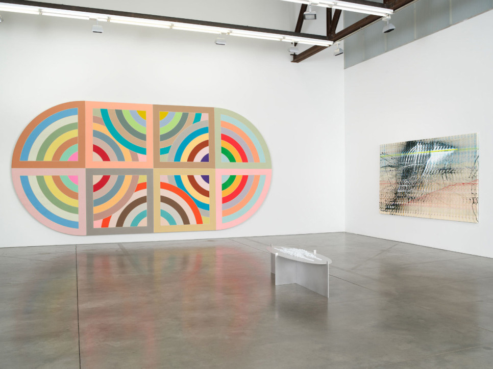 2 abstract paintings hanging on a gallery wall with 1 floor sculpture