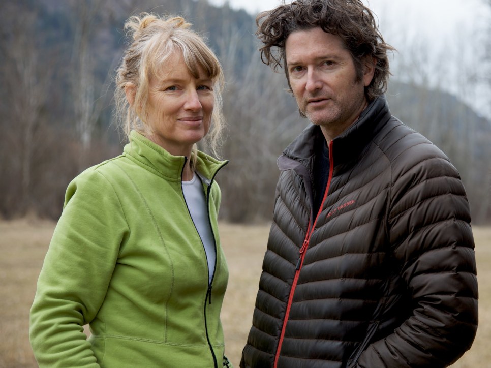 Portrait of the artists Janet Cardiff and George Bures Miller, standing in front of an open field