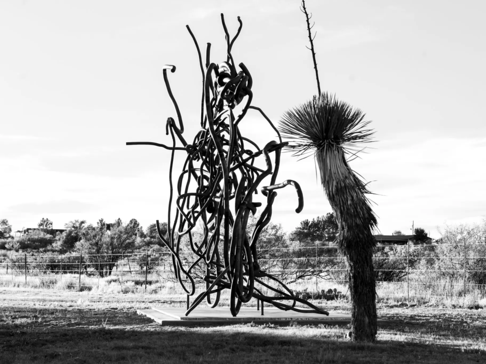 Black and white photo of a sculpture in a desert