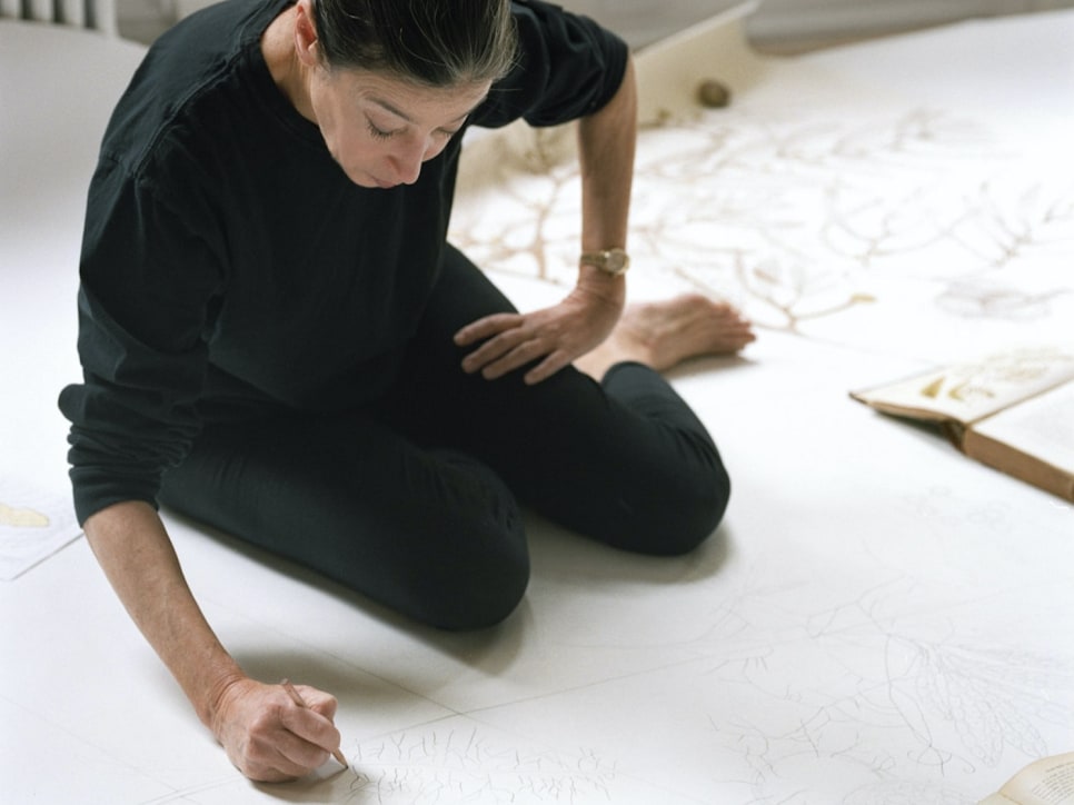 Color photograph of Michele Oka Doner drawing on the floor