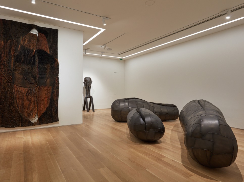 Installation view of sculptures and a textile work by Magdalena Abakanowicz