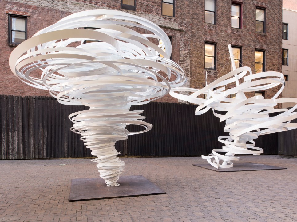 Outdoor installation view of white aluminum twisted sculptures by Alice Aycock