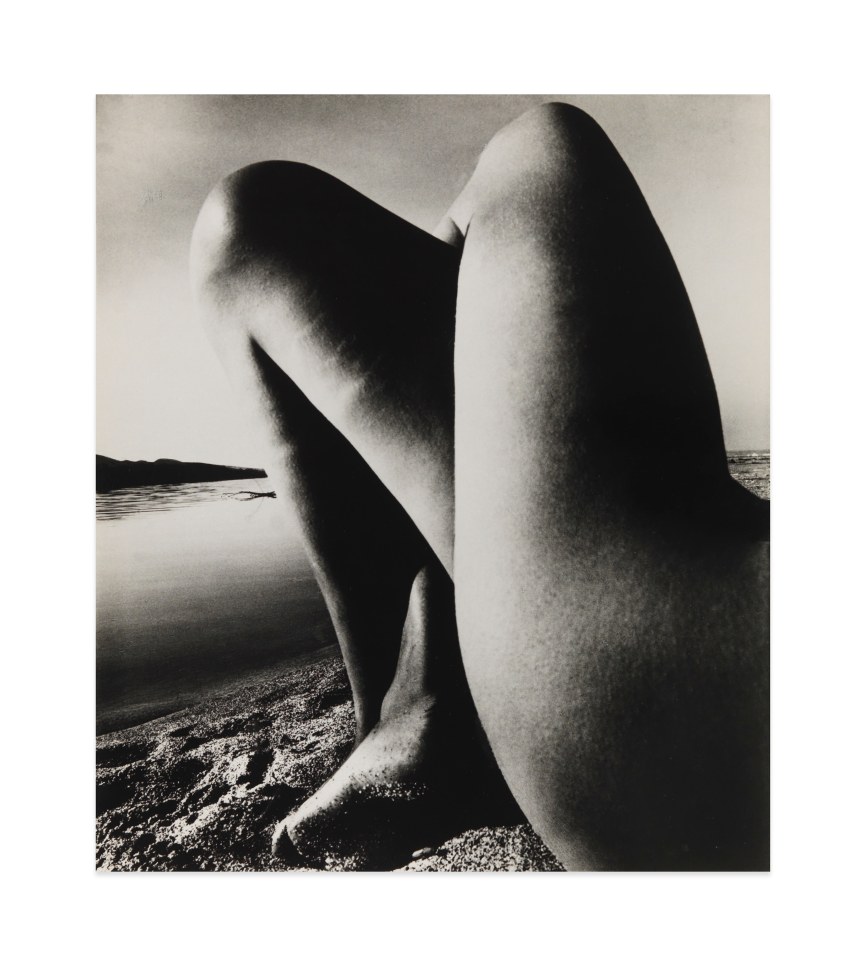 Black and white photograph by Bill Brandt showing nude crossed legs on the beach 
