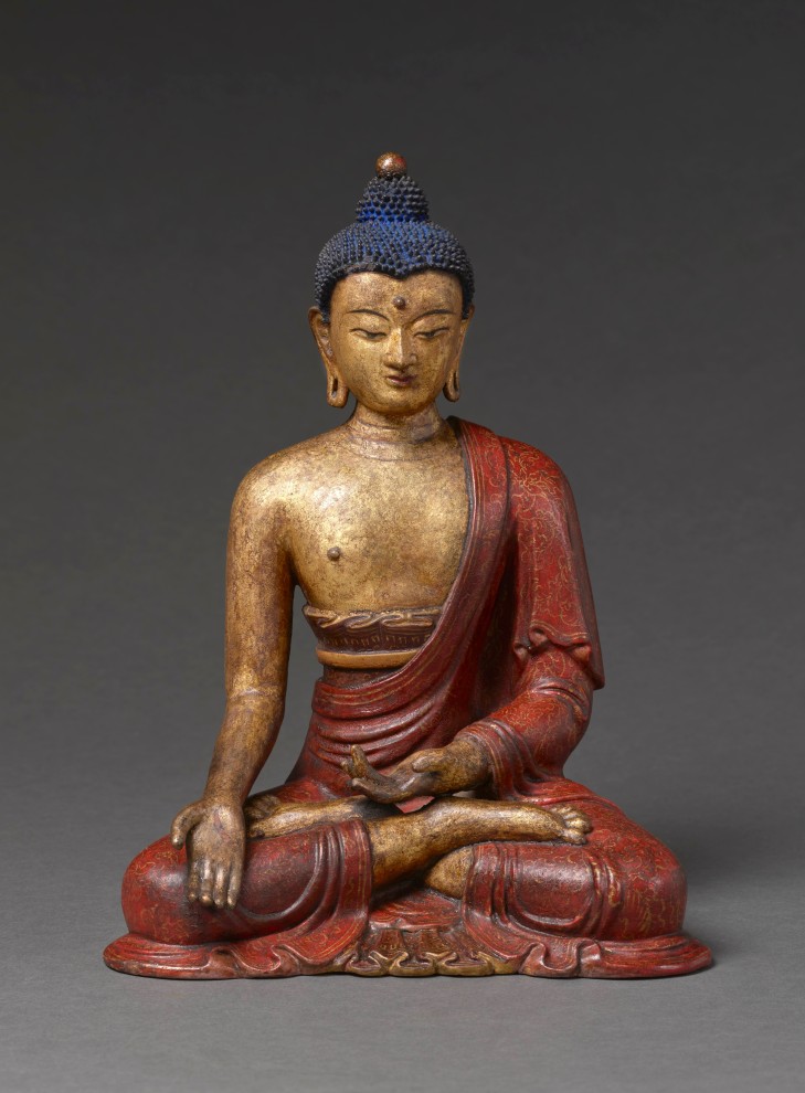 This rare gilt and polychrome lacquered clay sculpture shows the tathagata Ratnasambhava seated in dhyanasana with his hands displaying varada and dhyana mudras. 