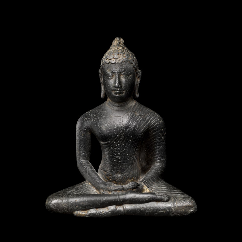 This small Buddha from the Anuradhapura period sits in the half-lotus posture (virasana), his right leg over his left