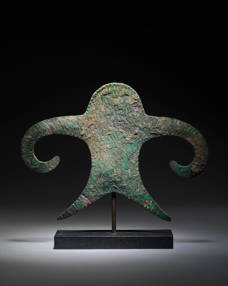 This enigmatic object is cast and hammered from a flat piece of copper into a representation of a male figure.